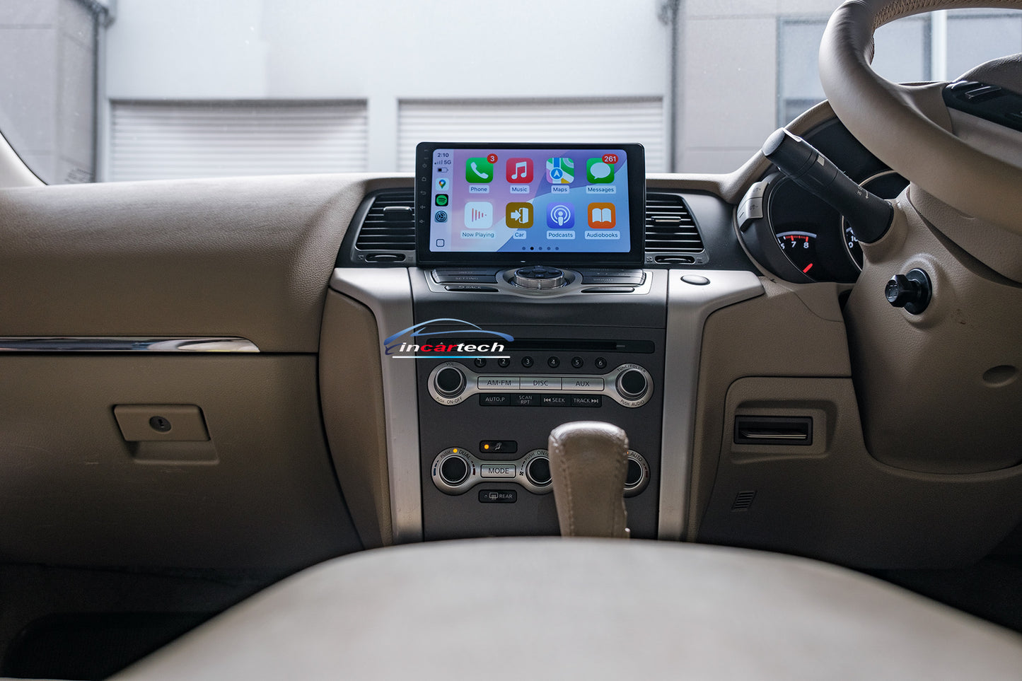 Car dashboard with a tablet displaying a music app interface.