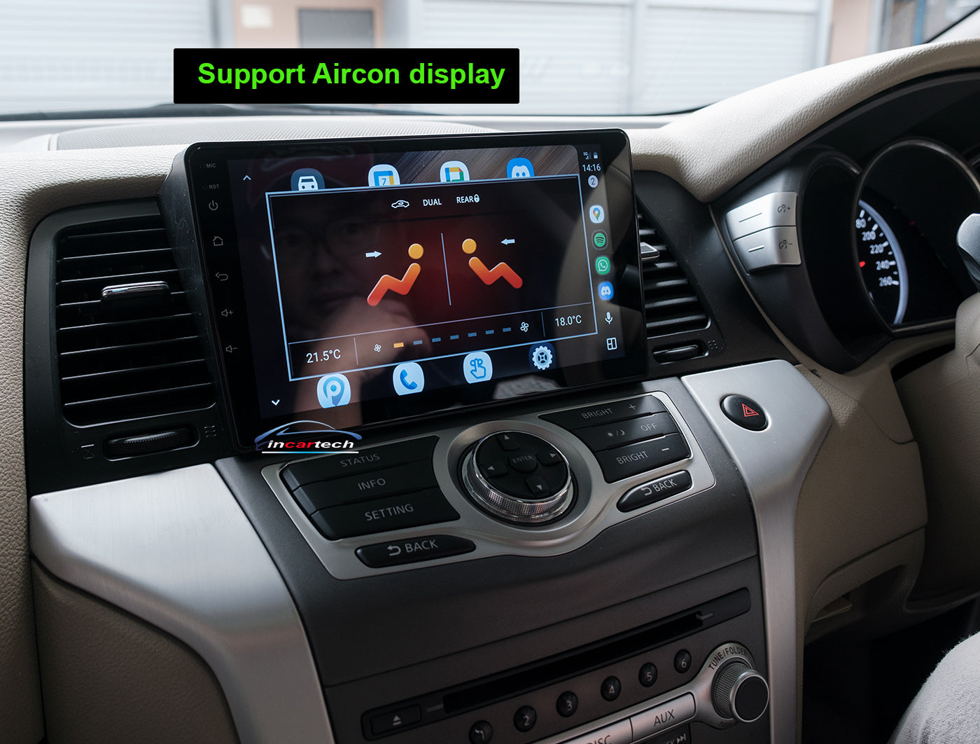 Car dashboard with a multimedia display and air conditioning control panel.