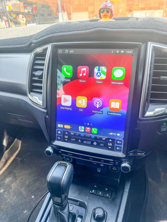 Car dashboard with a touchscreen display showing app icons.